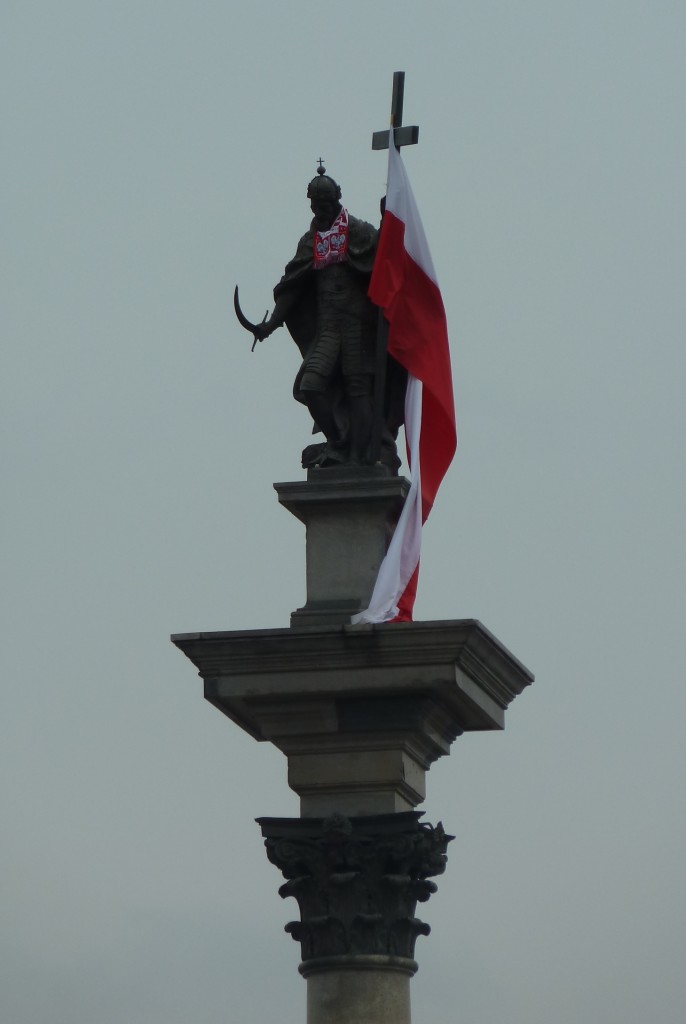 The statue of King Sigismund III atop the Sigismund Column in the Royal Castle Square, draped in Polish colors.
