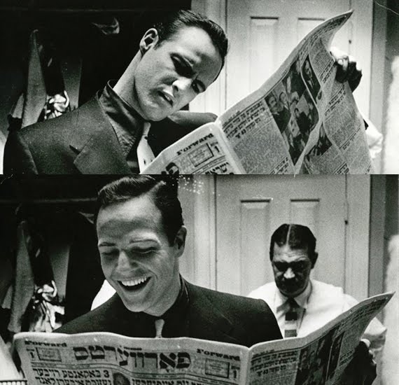 Marlon Brando reading a newspaper.