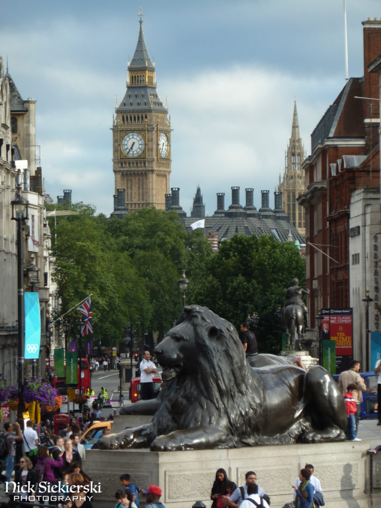 View of a lion statue and Big Ben from Trafalgar Square, London